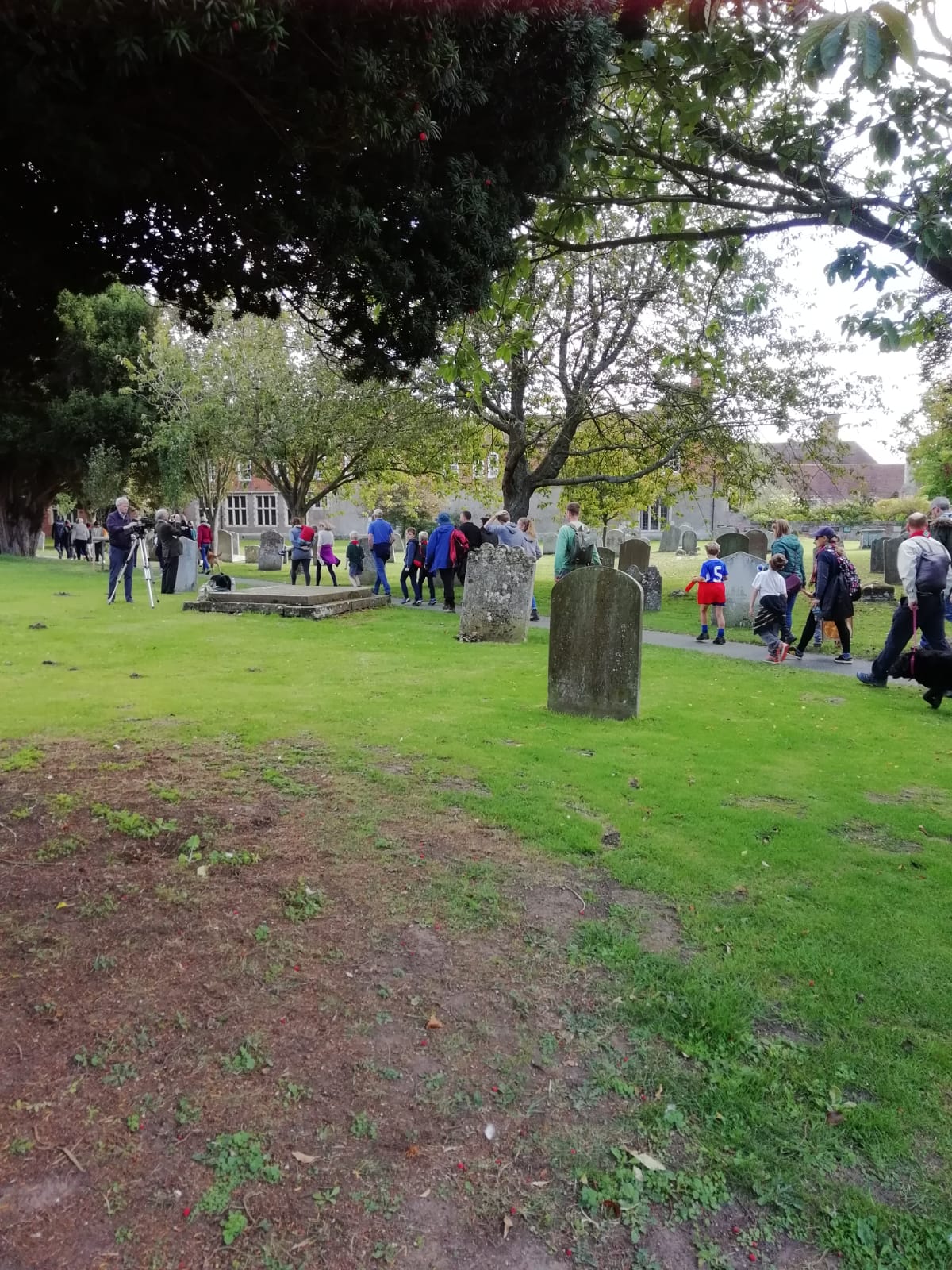 Group of walkers in church grounds.