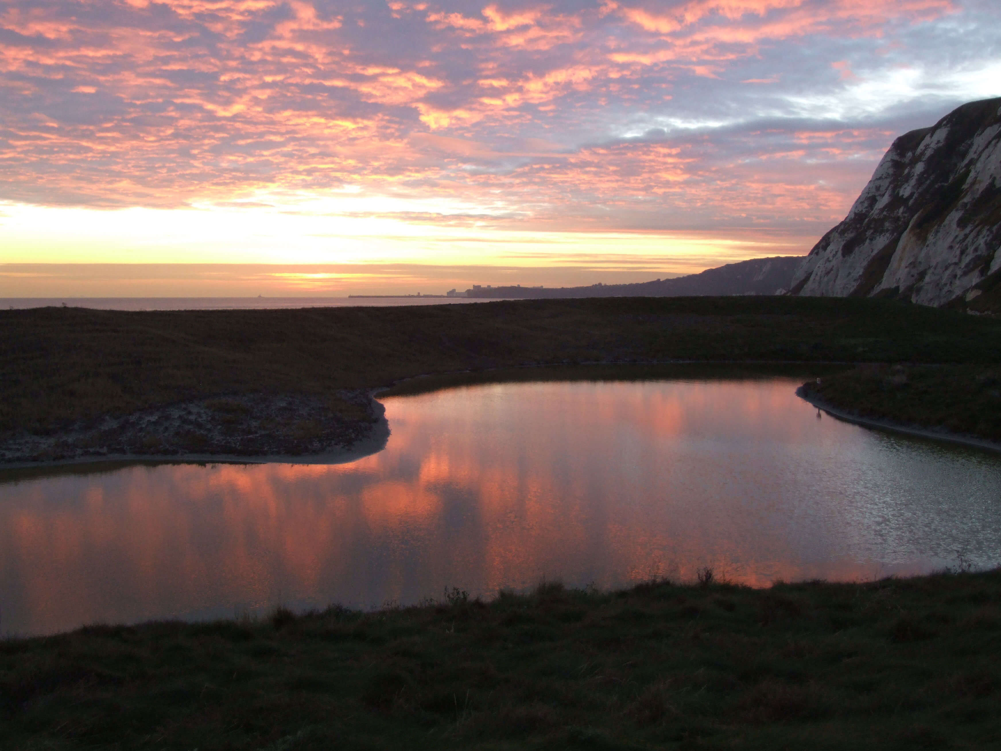 Samphire Hoe sunset view with cliffs and sea.