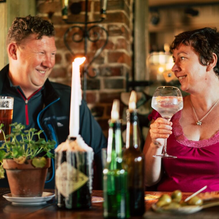 Couple eating in a coy pub.