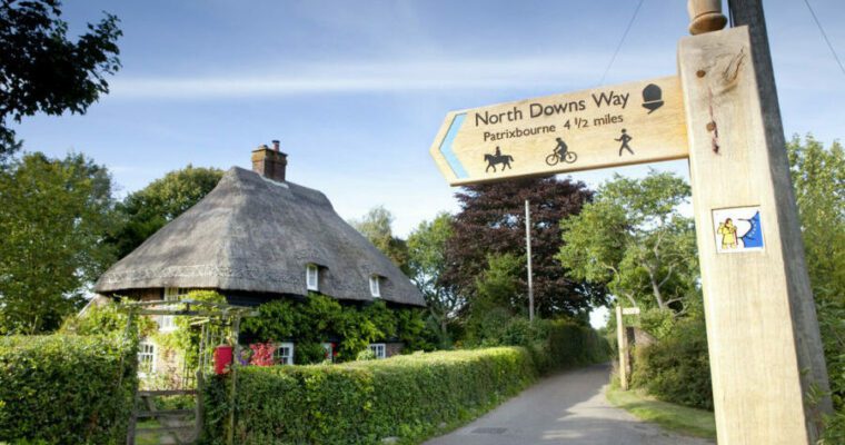 North downs way sign post in a country lane.