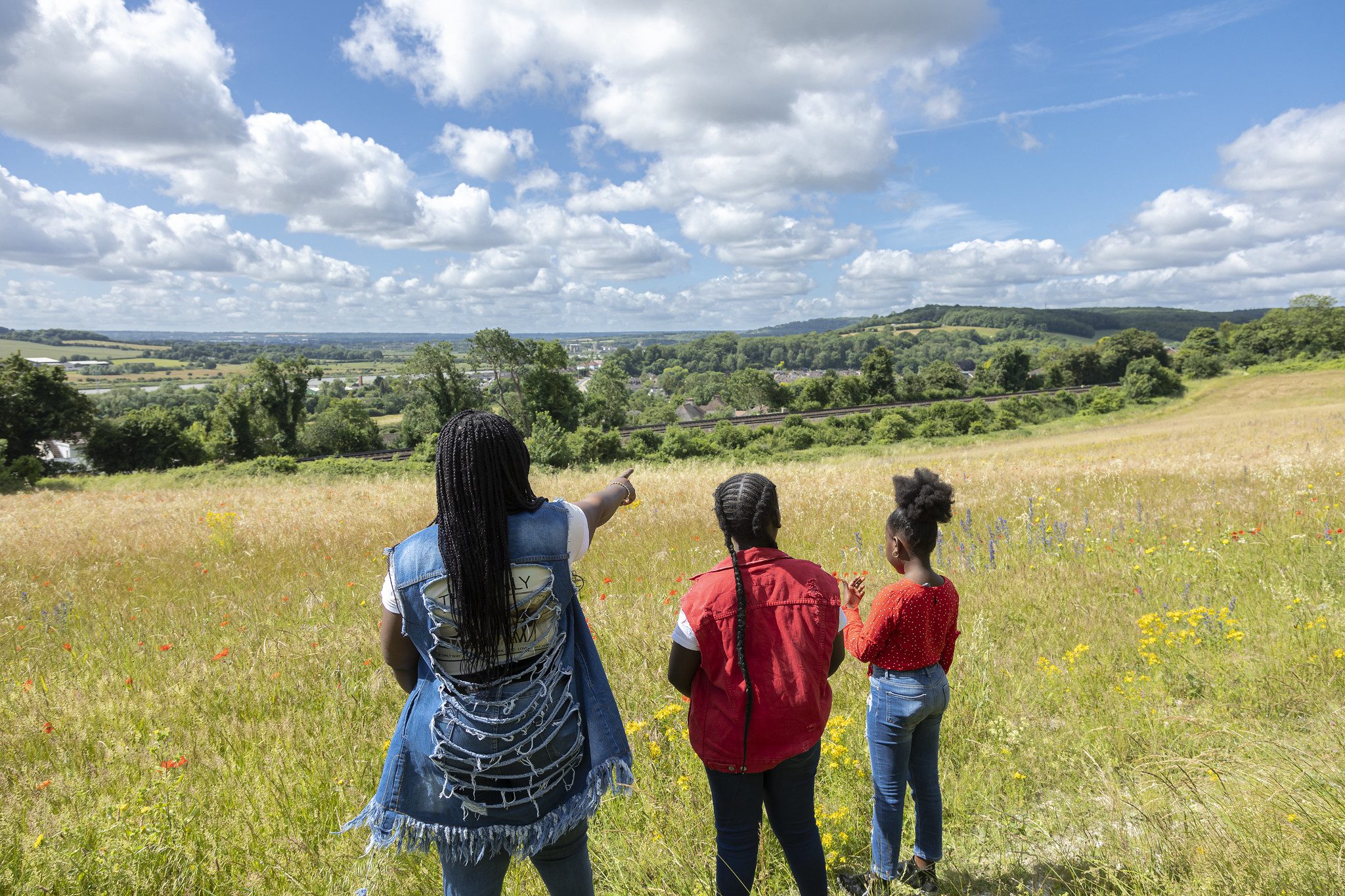 Family looking at the view across grassland