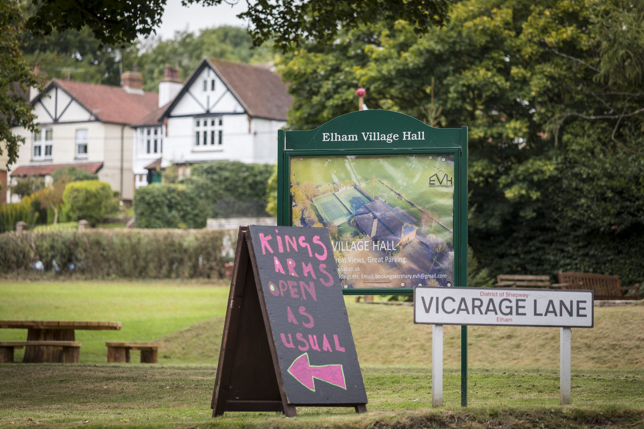 Village green with information board and houses behind