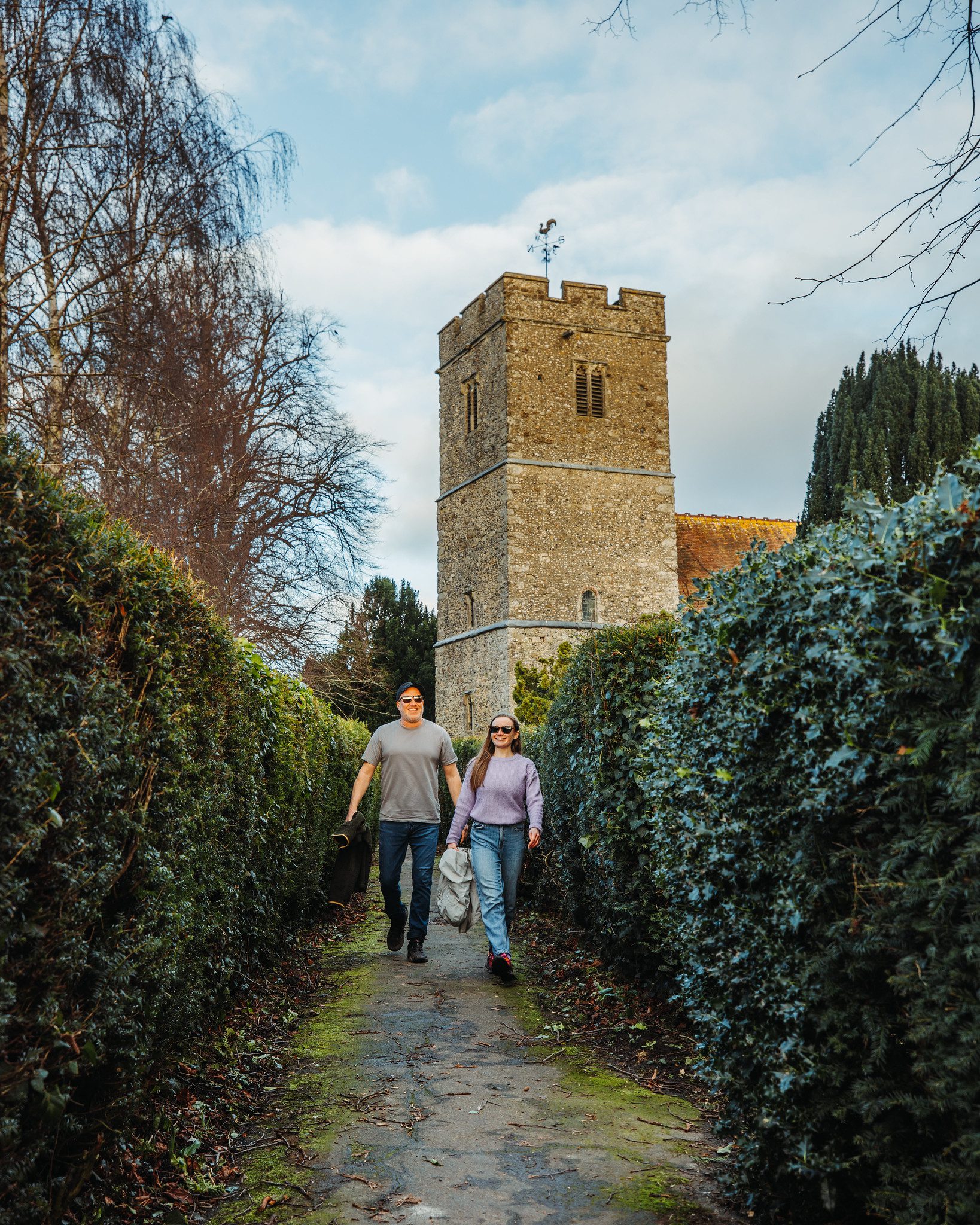 Couple walking in front of church tower