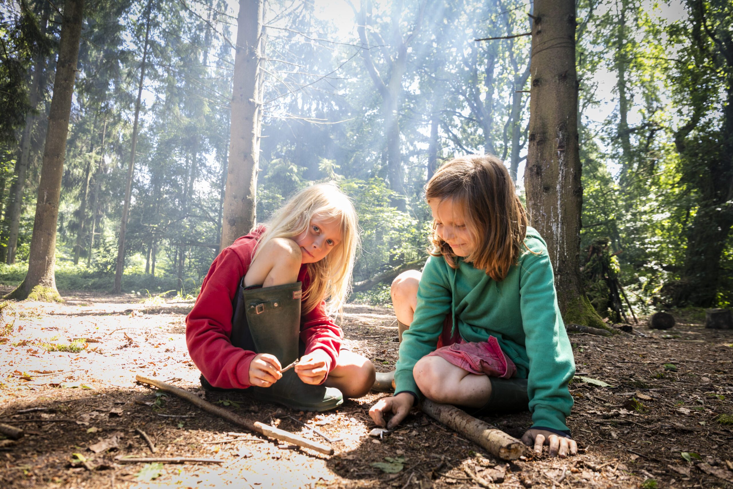 Two children playing in the woods