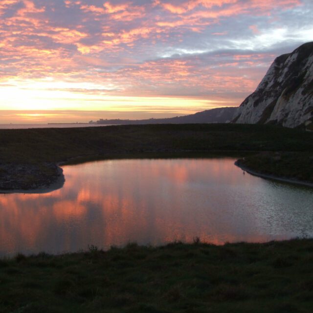 Samphire Hoe sunset view with cliffs and sea.