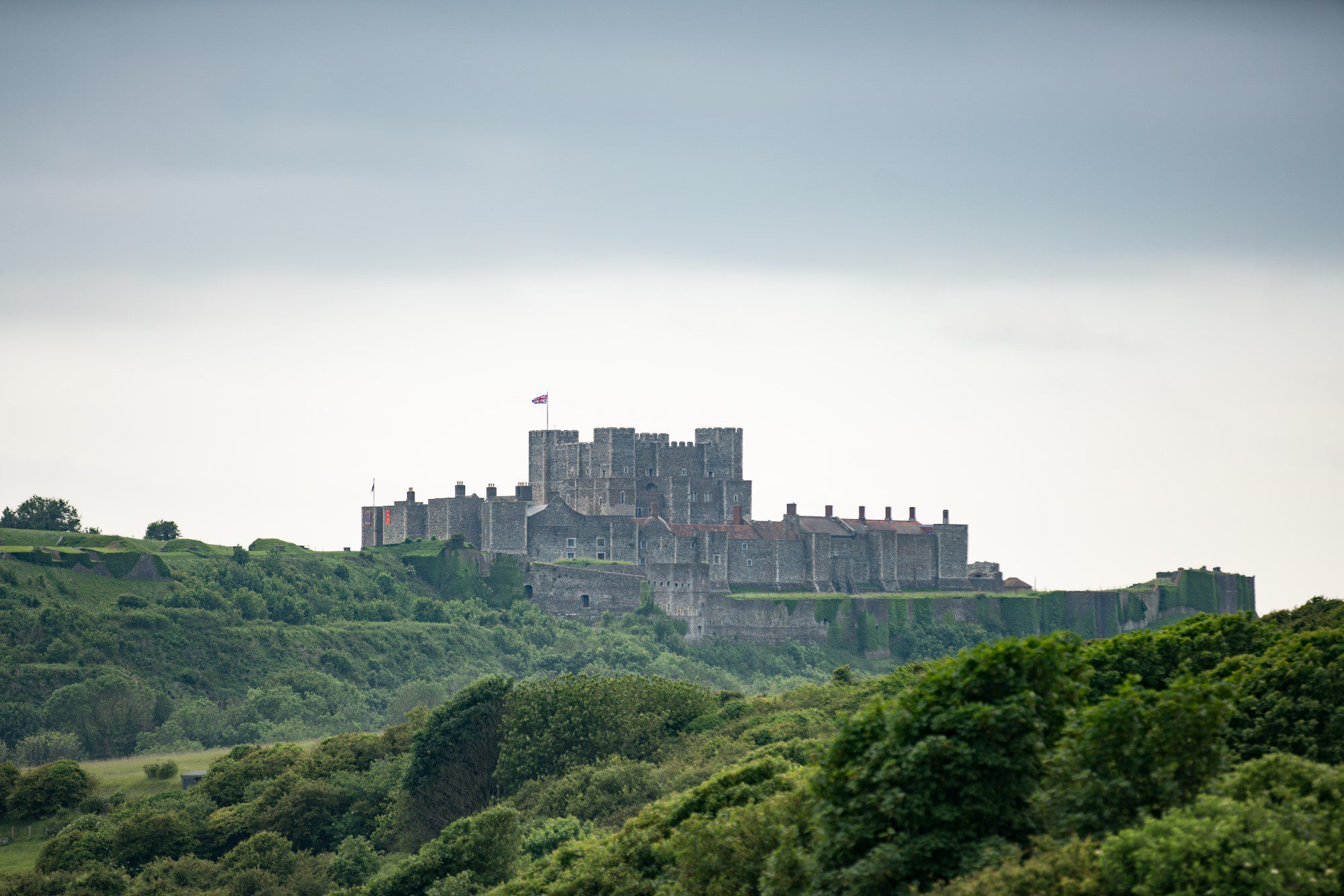 View of Dover Castle and surrounding grounds, on a misty day.