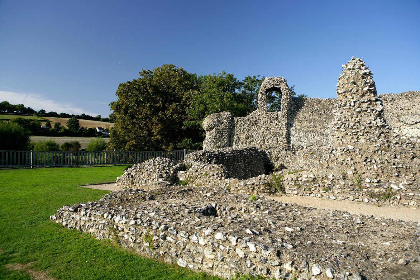Castle ruins at Eynsford, with grass and trees in view.