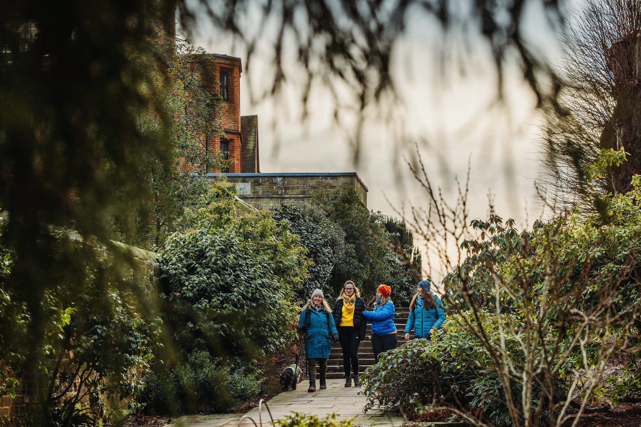 Four women walking through grounds of Chartwell House