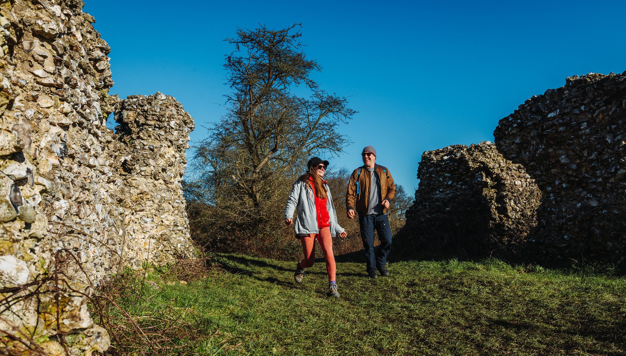 Couple walking amidst ruins of Thurnham Castle