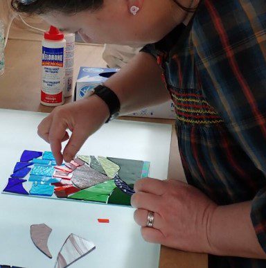 Woman preparing a stained glass mosaic