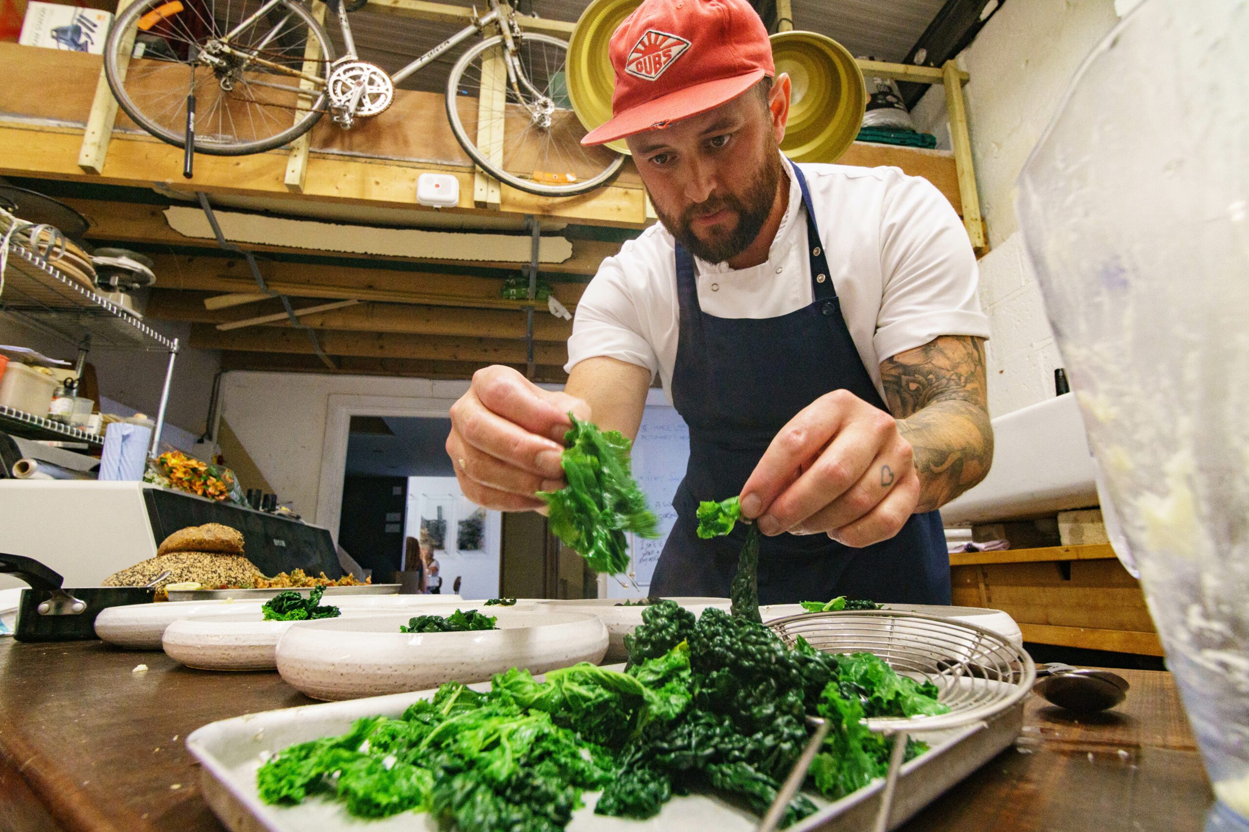 Chef dressing plate with greens