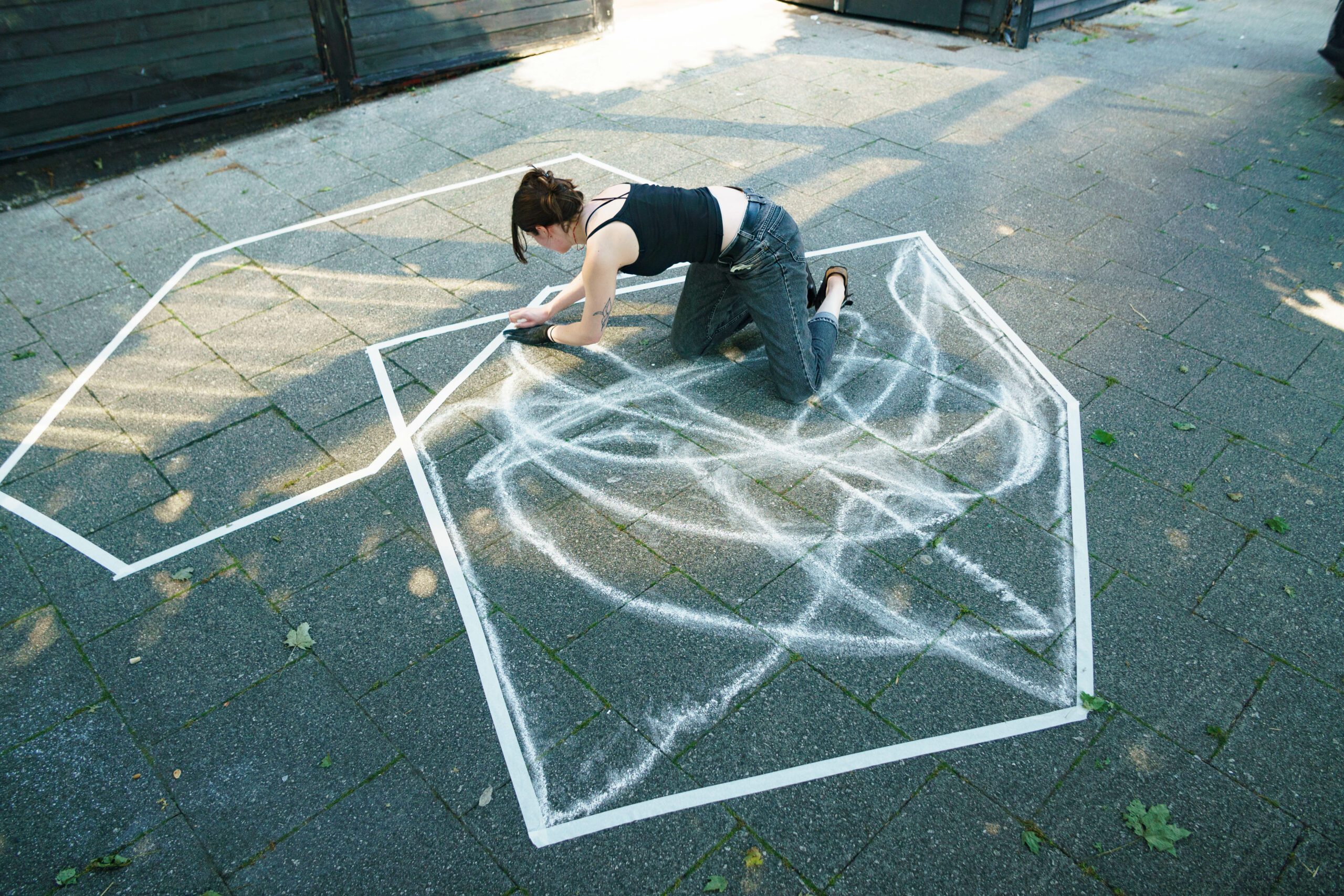 Artist drawing abstract shapes with chalk