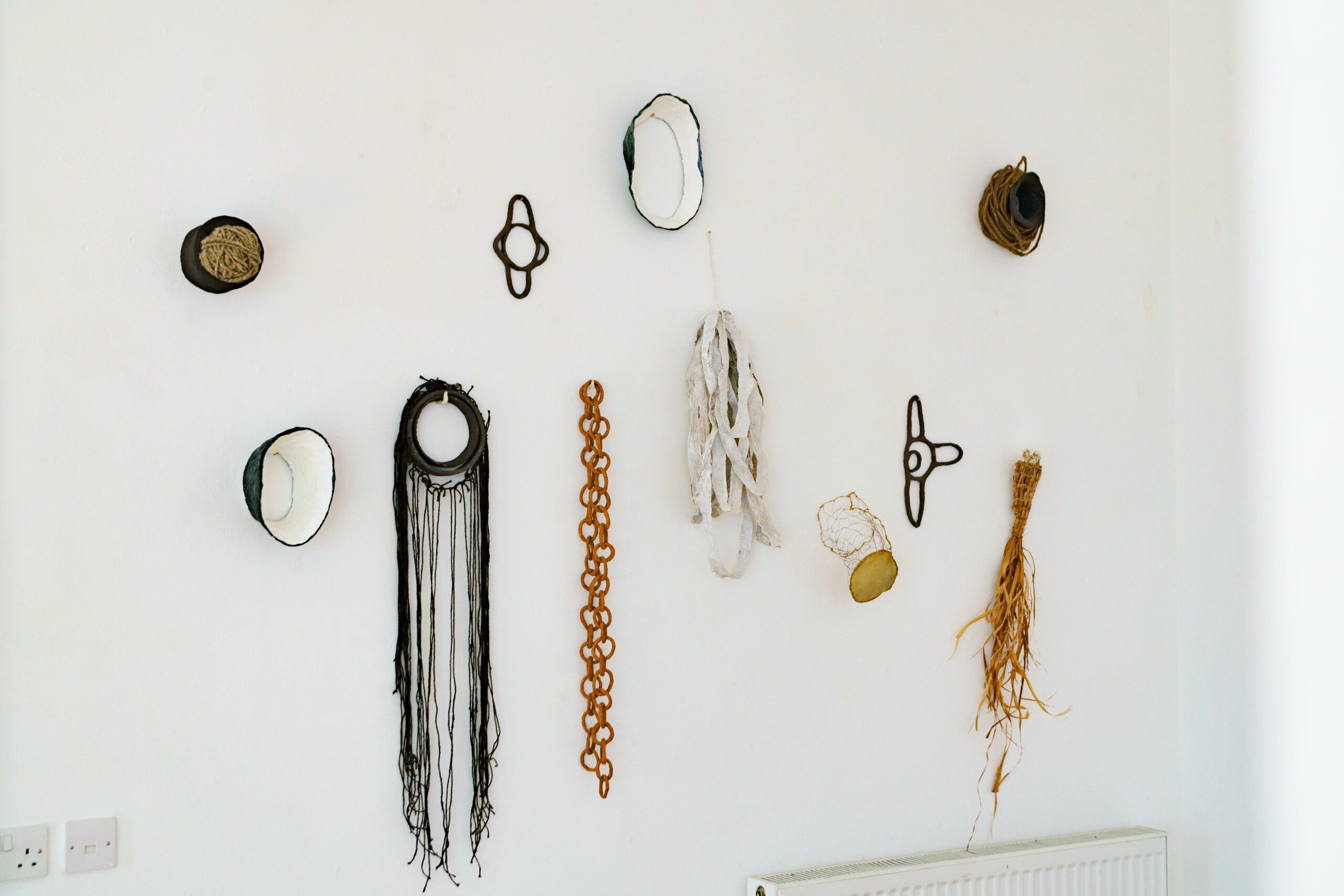 Braided artwork hanging on white wall