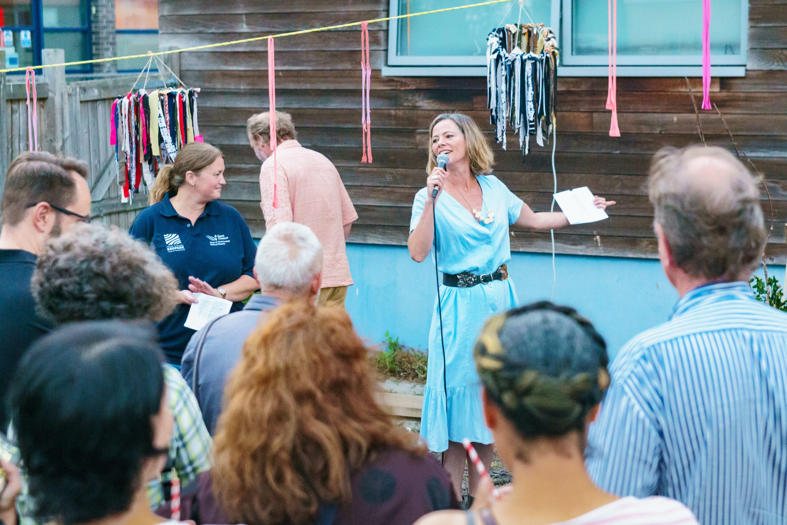 Audience watching woman performing on stage