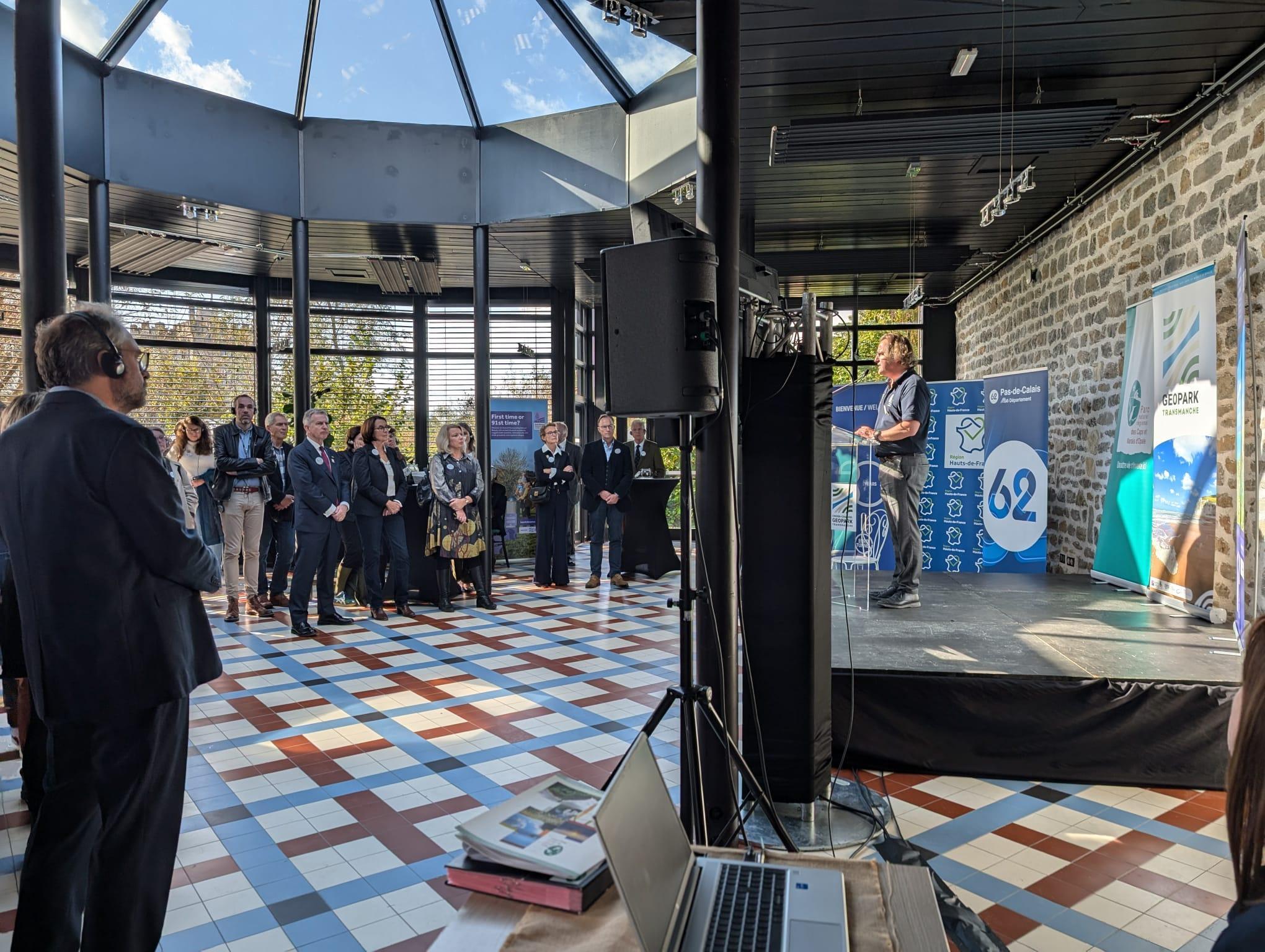 The official reception for the launch of the geopark gathers important partners and stakeholders. The event takes place in a formal setting, with speeches highlighting the significance of the geopark