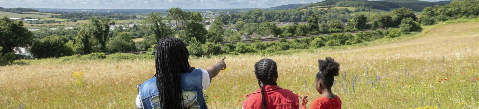 Family looking at the view across grassland