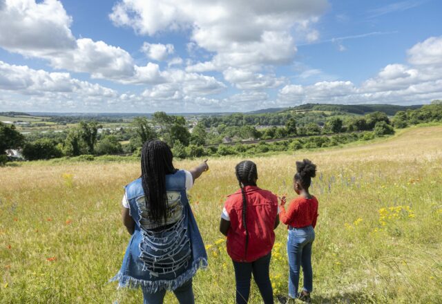 Family looking at the view across grassland