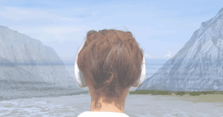 Head of a woman with ear phones looking out to sea.
