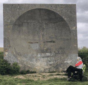 Gini Mirchell, founder of Wild With Wheels, pictured in front of the Abbot's Cliff Sound Mirror