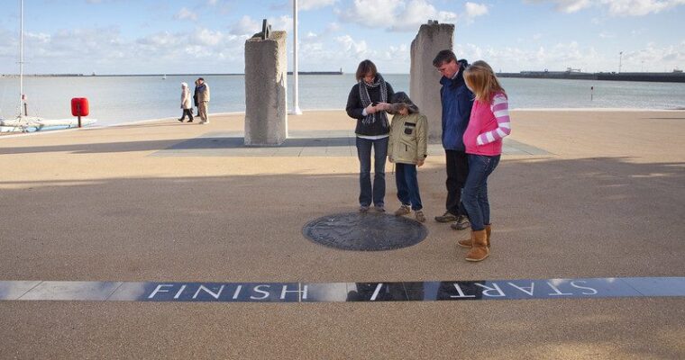 Three adults and young child standing, looking at Start/Finish artwork in Dover.